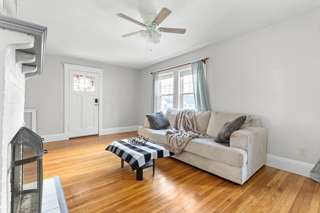 living room featuring hardwood / wood-style flooring and ceiling fan