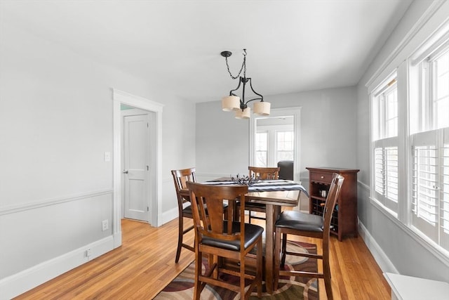 dining space featuring plenty of natural light, a chandelier, and light wood-type flooring