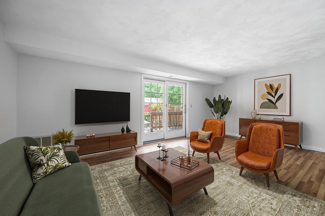 99 Apache Way Unit 99, Tewksbury, MA 01876 - living area with wood finished floors, baseboards, and a textured ceiling