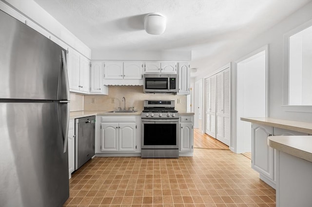 99 Apache Way Unit 99, Tewksbury, MA 01876 - kitchen with appliances with stainless steel finishes, a sink, light countertops, light flooring, and white cabinetry
