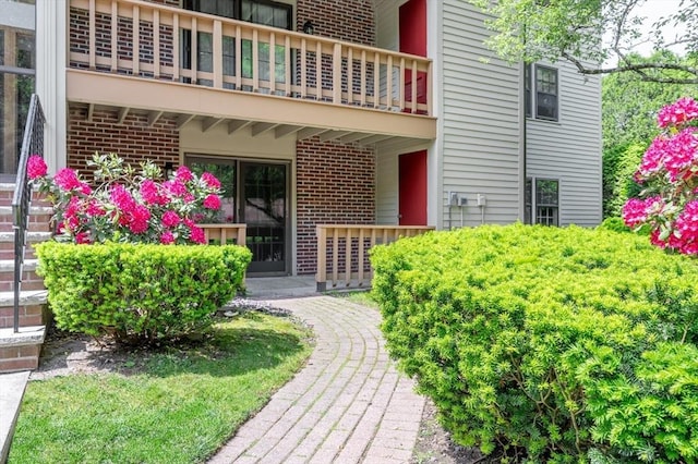 99 Apache Way Unit 99, Tewksbury, MA 01876 - view of exterior entry with a balcony and brick siding