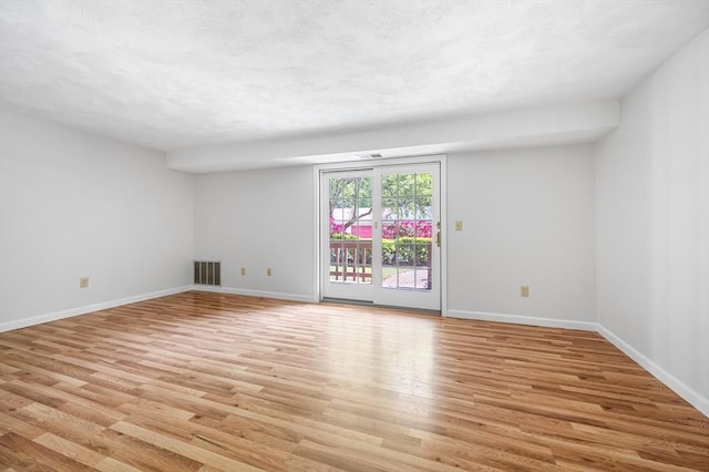 99 Apache Way Unit 99, Tewksbury, MA 01876 - unfurnished room featuring light wood-type flooring, baseboards, and a textured ceiling