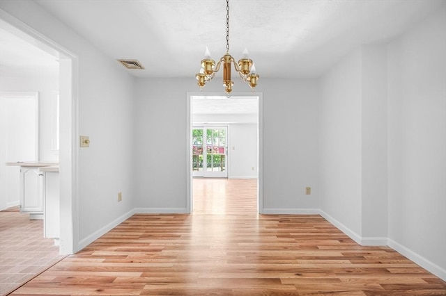 99 Apache Way Unit 99, Tewksbury, MA 01876 - spare room featuring a chandelier, light wood-style flooring, and baseboards