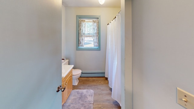 bathroom featuring vanity, a baseboard radiator, hardwood / wood-style flooring, and toilet