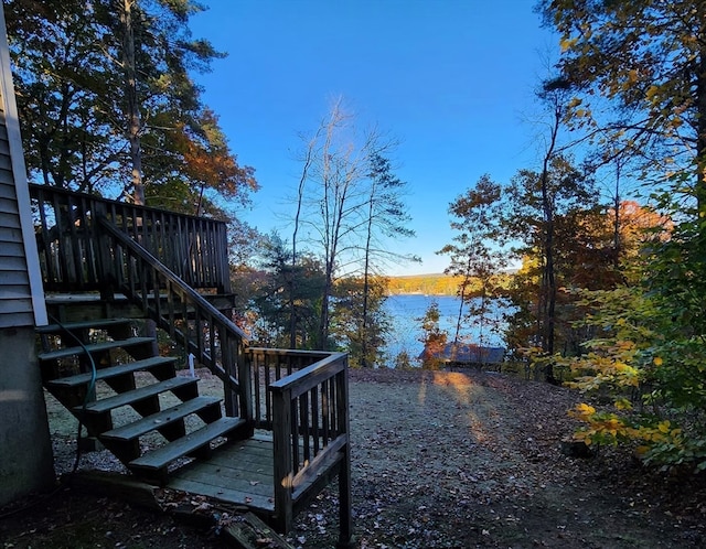 view of yard with a deck with water view