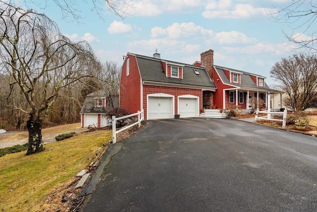 262 Homestead Ave, Rehoboth, MA 02769 - colonial inspired home featuring asphalt driveway, a porch, a gambrel roof, a chimney, and a shingled roof