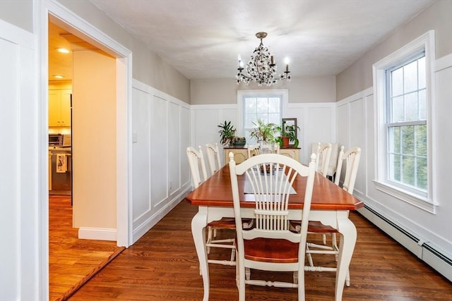 262 Homestead Ave, Rehoboth, MA 02769 - dining space with a decorative wall, a baseboard radiator, dark wood finished floors, a chandelier, and wainscoting