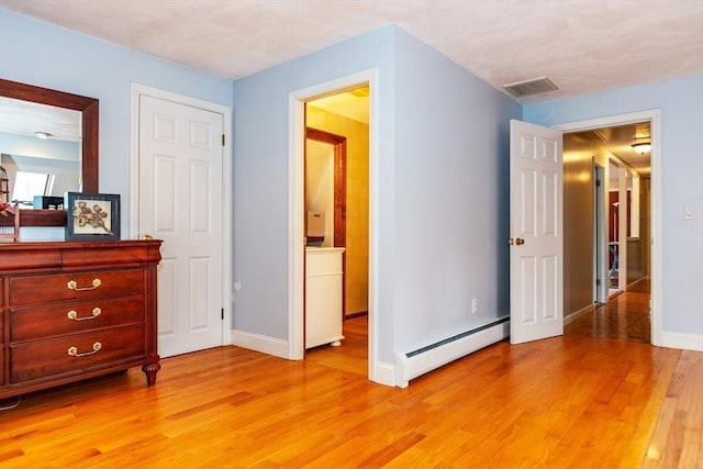 262 Homestead Ave, Rehoboth, MA 02769 - bedroom with a baseboard heating unit and light wood-style flooring