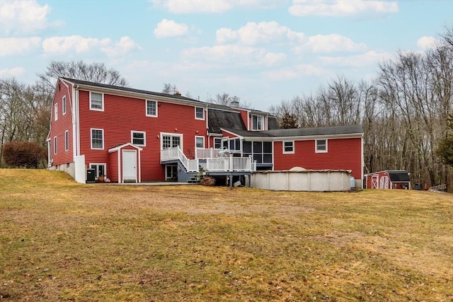 262 Homestead Ave, Rehoboth, MA 02769 - rear view of property with a storage unit, a deck, a sunroom, and a yard