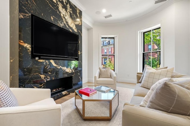 30 Concord Sq Unit 1, Boston, MA 02118 - living room featuring a fireplace, crown molding, visible vents, baseboards, and wood finished floors