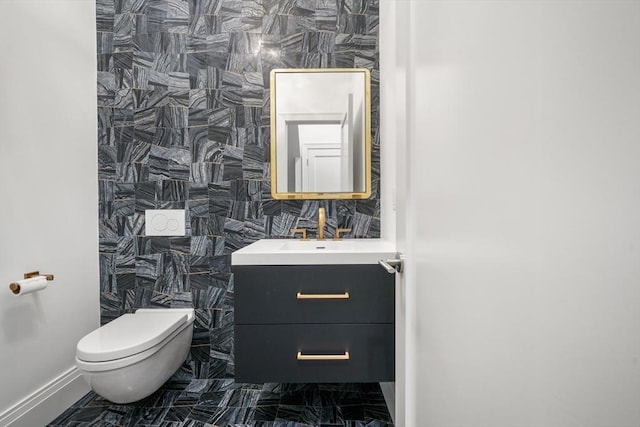 30 Concord Sq Unit 1, Boston, MA 02118 - bathroom with baseboards, marble finish floor, toilet, and vanity