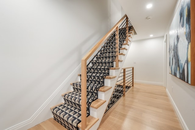 stairway featuring wood-type flooring