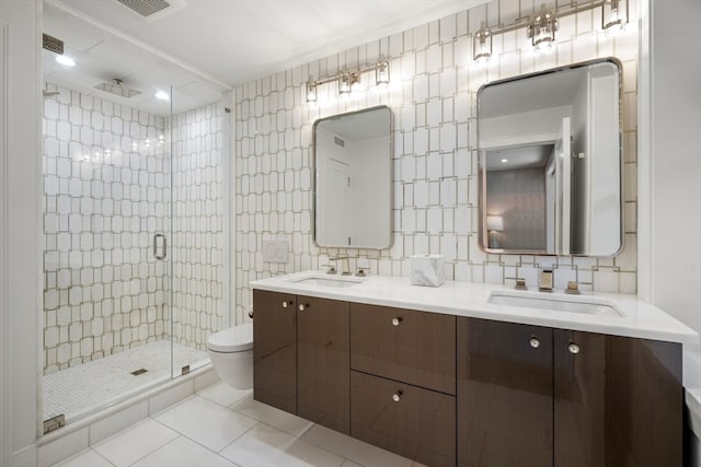 bathroom with toilet, tile patterned flooring, a shower with shower door, vanity, and tile walls