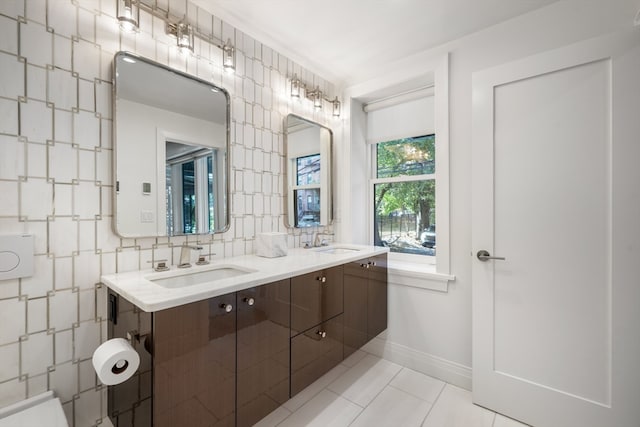 bathroom with vanity, tile patterned floors, and backsplash