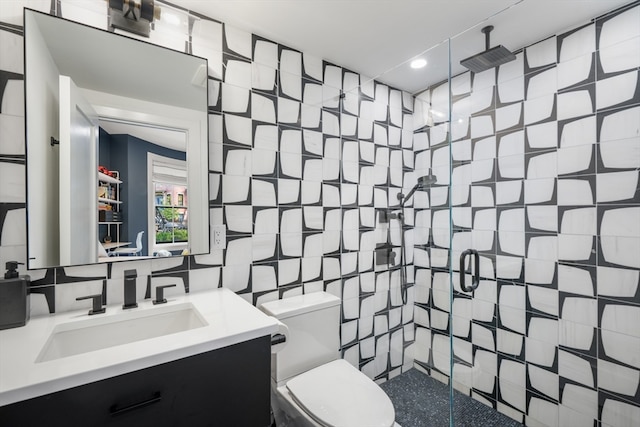 bathroom featuring tile walls, vanity, toilet, and an enclosed shower