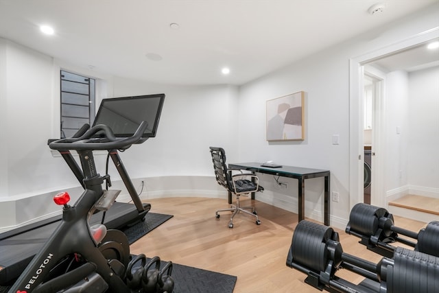 exercise area with washer / clothes dryer and hardwood / wood-style floors