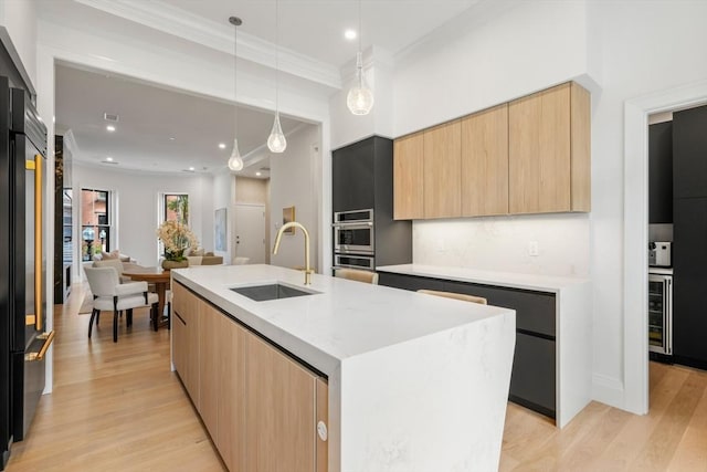 30 Concord Sq Unit 1, Boston, MA 02118 - kitchen featuring light brown cabinets, light wood finished floors, a sink, modern cabinets, and wine cooler