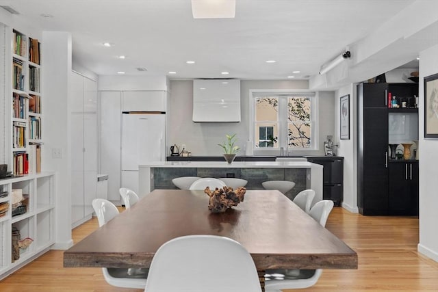 dining area featuring light wood-type flooring, baseboards, and recessed lighting