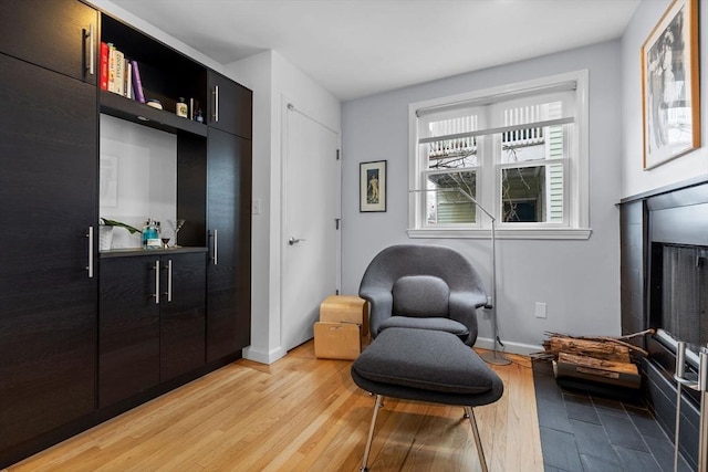 living area with light wood-style floors and baseboards