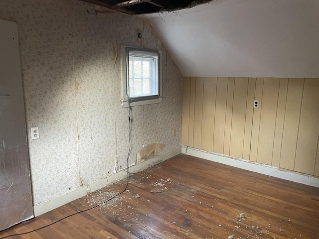 bonus room with hardwood / wood-style flooring and vaulted ceiling