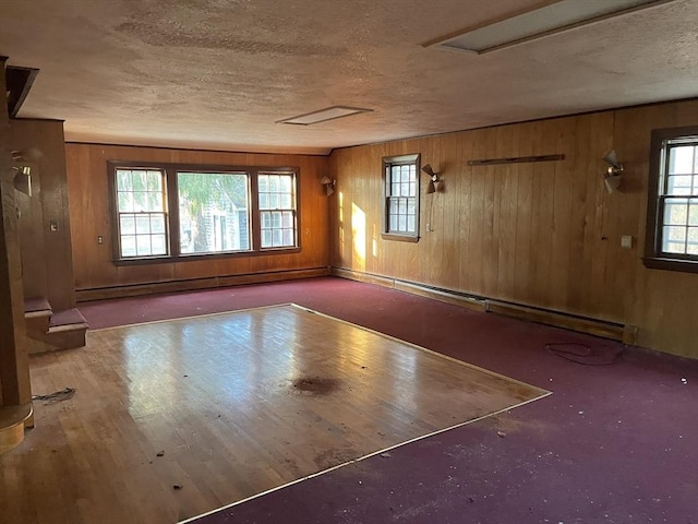 interior space featuring a baseboard radiator and wooden walls