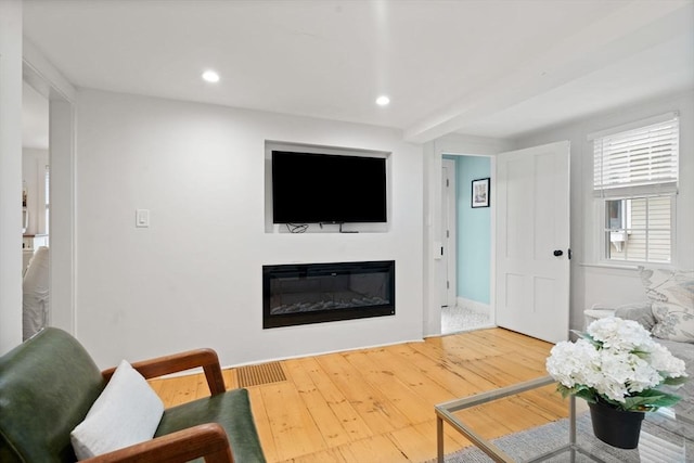 11 Congress St, Newburyport, MA 01950 - living area with a glass covered fireplace, wood-type flooring, recessed lighting, and baseboards