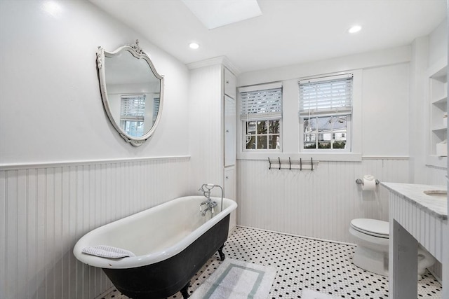 11 Congress St, Newburyport, MA 01950 - bathroom featuring wainscoting, a freestanding bath, vanity, toilet, and recessed lighting