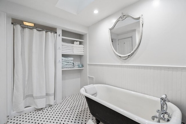 11 Congress St, Newburyport, MA 01950 - bathroom featuring wainscoting, a freestanding tub, built in features, recessed lighting, and tile patterned floors