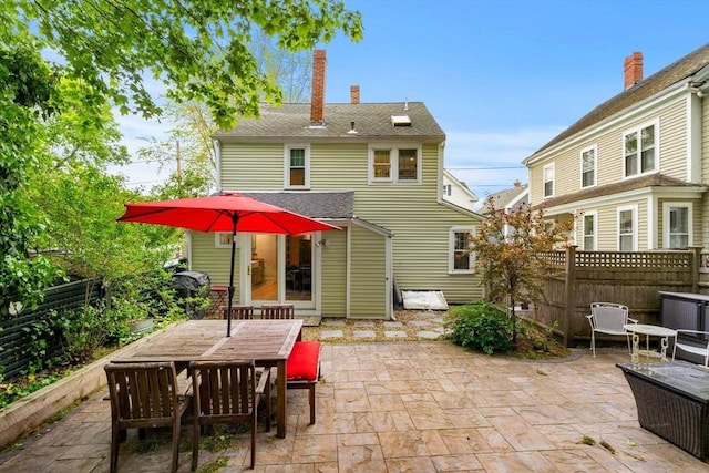 11 Congress St, Newburyport, MA 01950 - rear view of house with a patio, outdoor dining space, and a chimney