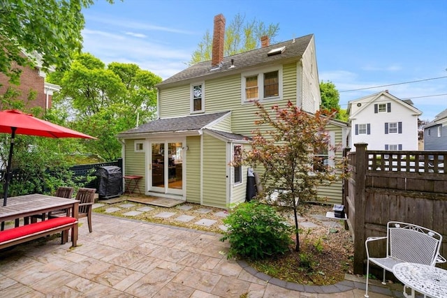 11 Congress St, Newburyport, MA 01950 - back of property featuring outdoor dining area, a patio, a chimney, roof with shingles, and an outdoor structure