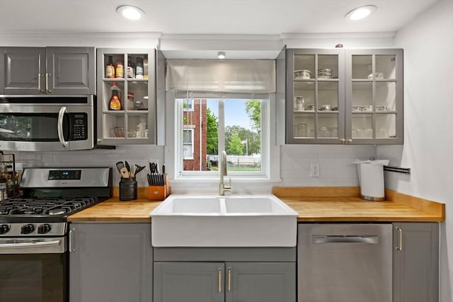 11 Congress St, Newburyport, MA 01950 - kitchen featuring appliances with stainless steel finishes, gray cabinetry, a sink, butcher block countertops, and crown molding
