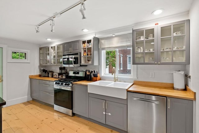 11 Congress St, Newburyport, MA 01950 - kitchen with gray cabinetry, appliances with stainless steel finishes, a sink, butcher block counters, and tasteful backsplash