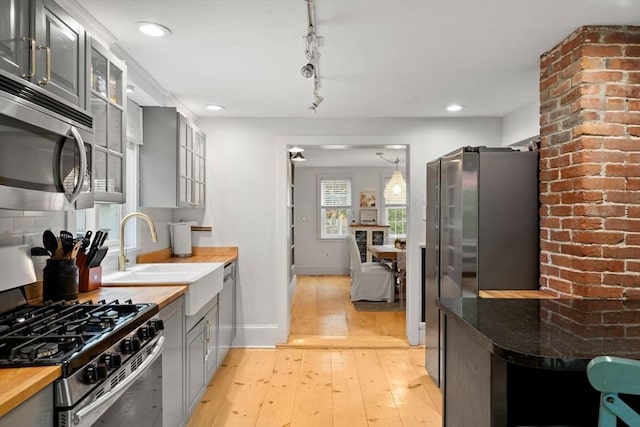 11 Congress St, Newburyport, MA 01950 - kitchen with stainless steel appliances, gray cabinetry, a sink, wooden counters, and recessed lighting