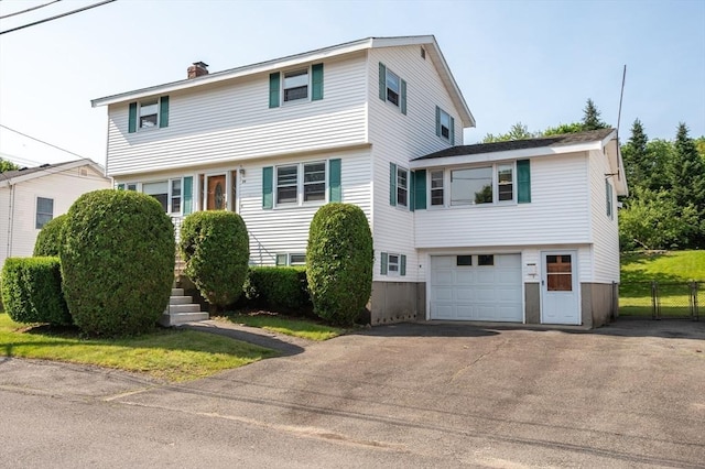34 Buena Vista Ave, Salem, MA 01970 - colonial house with asphalt driveway, a garage, and a chimney