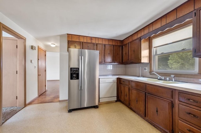 34 Buena Vista Ave, Salem, MA 01970 - kitchen featuring stainless steel fridge with ice dispenser, dishwasher, light countertops, tasteful backsplash, and brown cabinets