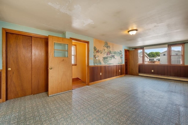 34 Buena Vista Ave, Salem, MA 01970 - unfurnished room with a baseboard heating unit, wooden walls, and wainscoting