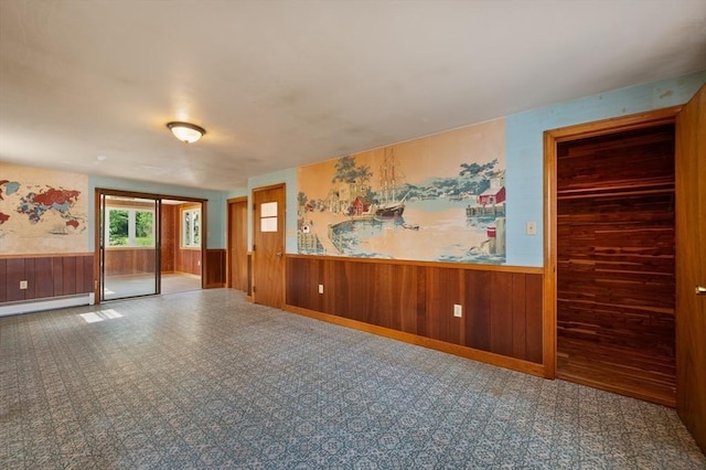 34 Buena Vista Ave, Salem, MA 01970 - empty room featuring wainscoting, a baseboard heating unit, and wood walls