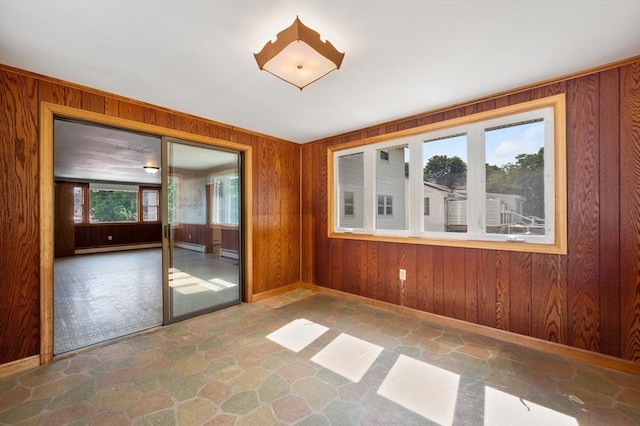 34 Buena Vista Ave, Salem, MA 01970 - spare room with stone floors, wooden walls, and a baseboard heating unit