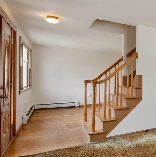 34 Buena Vista Ave, Salem, MA 01970 - foyer entrance with a baseboard heating unit, stairs, and wood finished floors