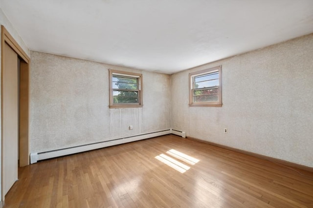 34 Buena Vista Ave, Salem, MA 01970 - unfurnished bedroom with a baseboard heating unit, wood finished floors, and a closet