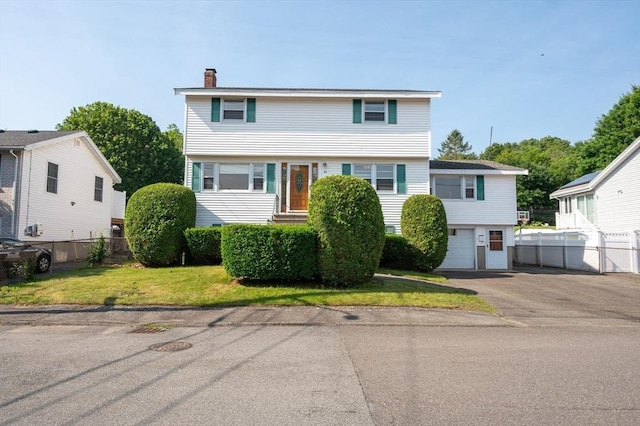 34 Buena Vista Ave, Salem, MA 01970 - colonial-style house featuring a chimney, driveway, and an attached garage