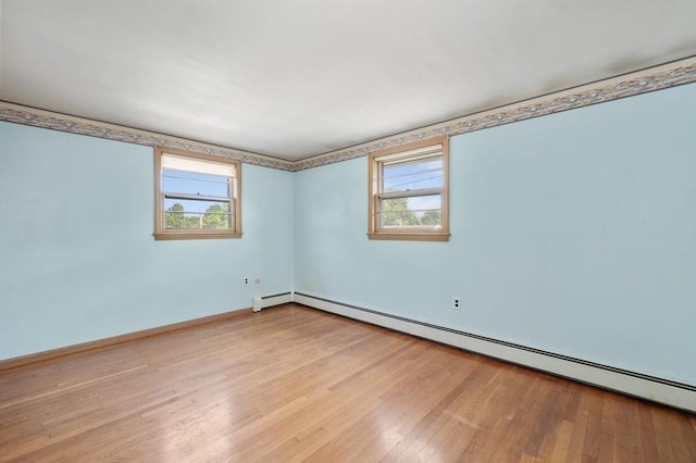 34 Buena Vista Ave, Salem, MA 01970 - empty room with baseboard heating, plenty of natural light, and wood finished floors