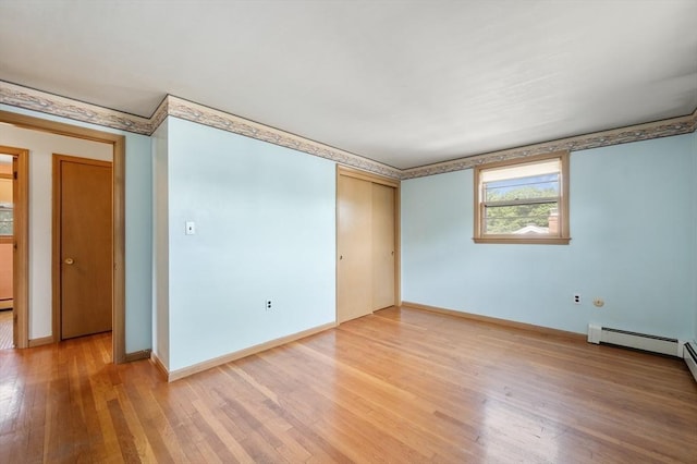 34 Buena Vista Ave, Salem, MA 01970 - empty room featuring light wood-style flooring and a baseboard heating unit
