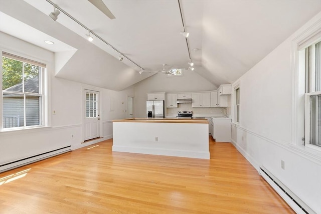 23 Centre Ave, Belmont, MA 02478 - kitchen with stainless steel appliances, track lighting, a baseboard radiator, under cabinet range hood, and white cabinetry