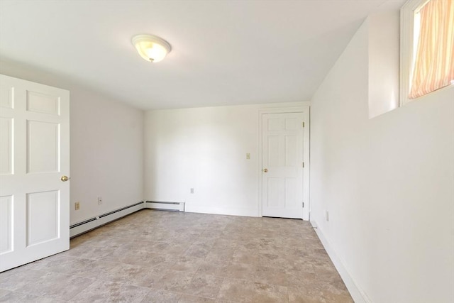 23 Centre Ave, Belmont, MA 02478 - empty room featuring stone finish flooring, a baseboard heating unit, and baseboards