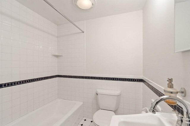 23 Centre Ave, Belmont, MA 02478 - full bathroom featuring tile walls, shower / bathtub combination, toilet, a sink, and wainscoting