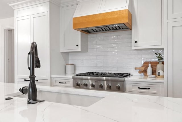 23 Centre Ave, Belmont, MA 02478 - kitchen featuring custom exhaust hood, stainless steel gas cooktop, backsplash, white cabinets, and a sink