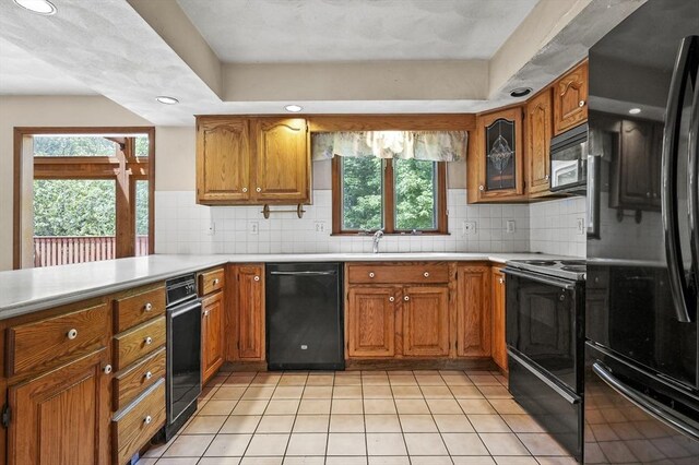 3 Westview Ter, Woburn, MA 01801 - kitchen with black appliances, brown cabinets, light countertops, tasteful backsplash, and recessed lighting
