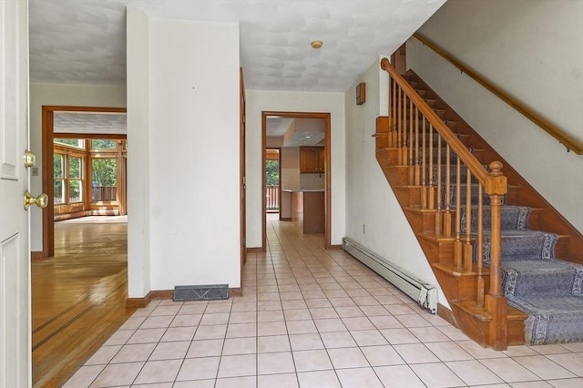 3 Westview Ter, Woburn, MA 01801 - entryway featuring a baseboard heating unit, plenty of natural light, stairway, and baseboards