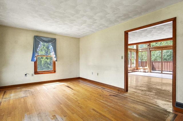 3 Westview Ter, Woburn, MA 01801 - empty room featuring baseboards, wood-type flooring, and a textured ceiling